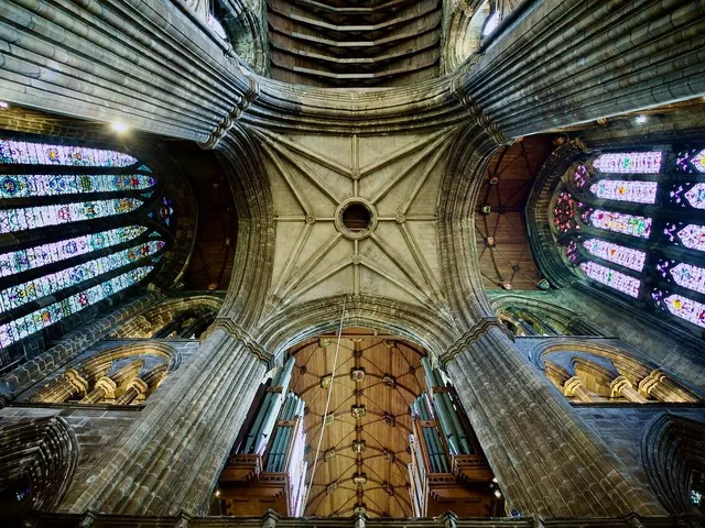 Looking up at the vaulted ceiling and stained glass inside Glasgow Cathedral