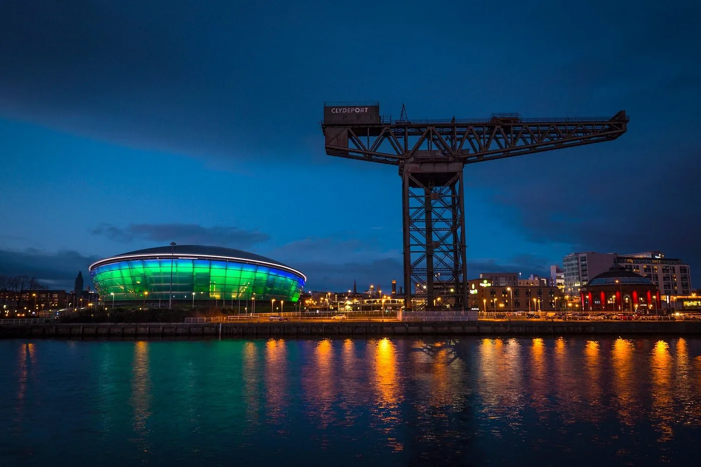 The OVO Hydro and Finnieston Crane lit up at night on the River Clyde, Glasgow