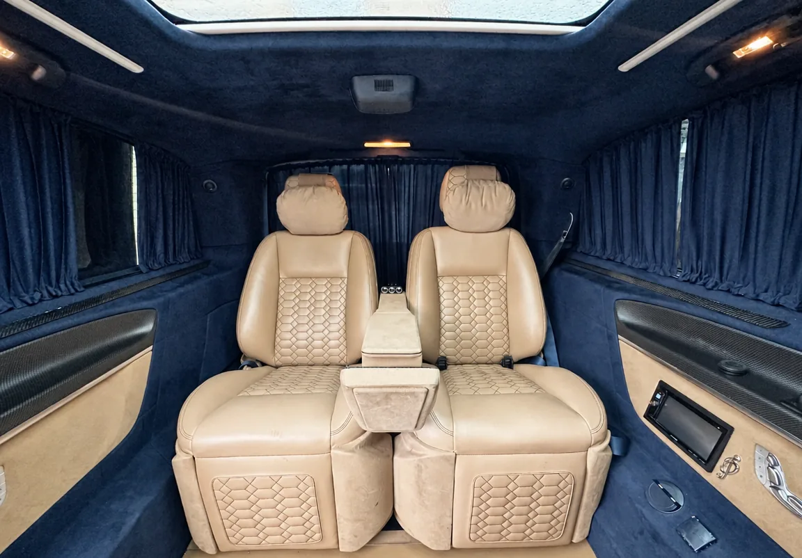 V-Class cabin interior with twin reclining leather captain seats and privacy curtains