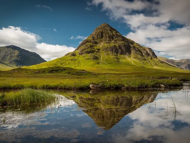 A Glencoe mountain reflected in a lochan beside the A82