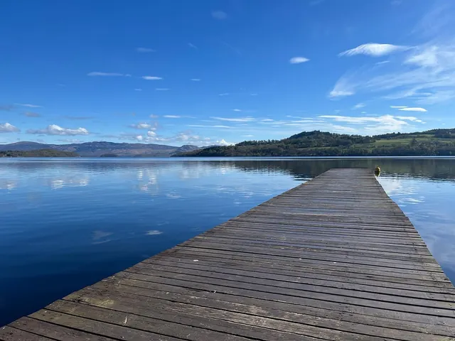 A jetty on a still Loch Lomond